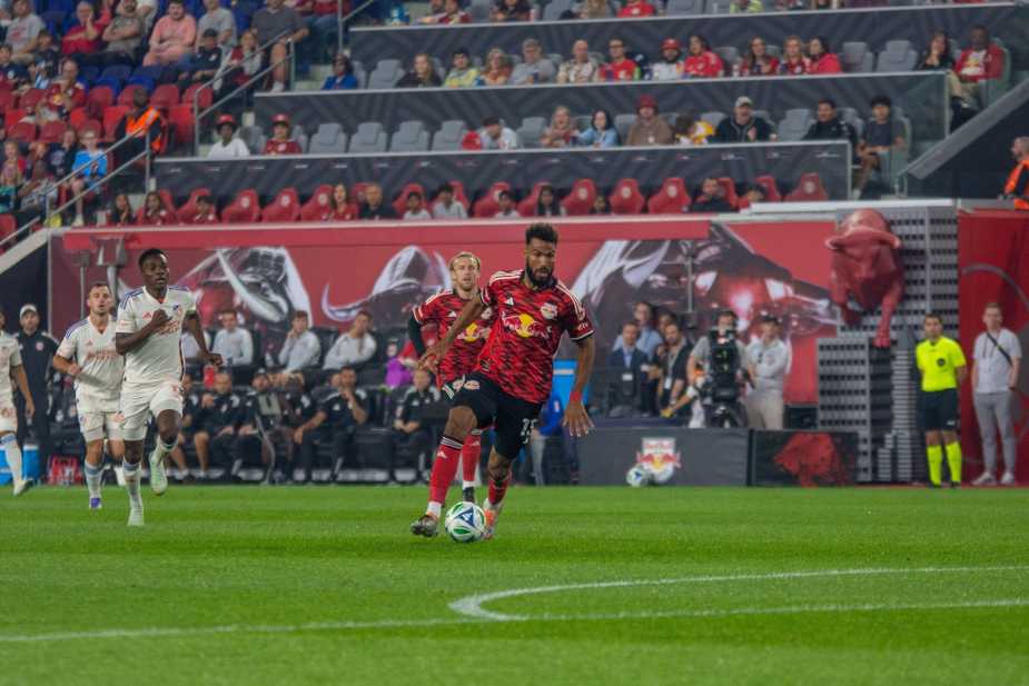New York Red Bulls forward Eric Maxim Choupo-Moting dribbles toward the box while being pursued by FC Cincinnati defenders during the Red Bulls' 0-1 loss at Sports Illustrated Stadium on October 4, 2025