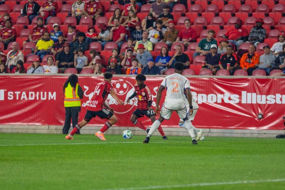 New York Red Bulls forward Mohammed Sofo dribbles down the sideline against FC Cincinnati right-back Alvas Powell during the Red Bulls' 0-1 loss at Sports Illustrated Stadium on October 4, 2025