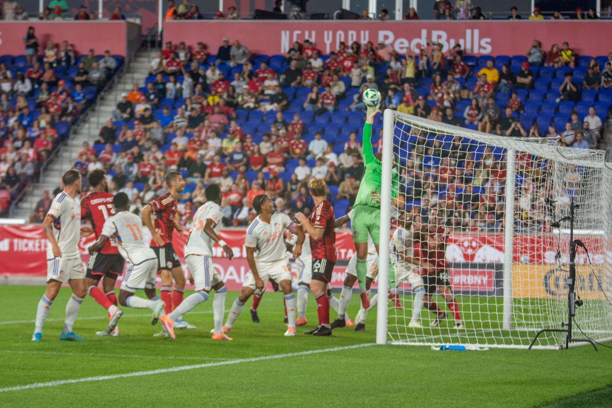 FC Cincinnati goalkeeper Evan Louro leaps to punch away a corner kick attempt by New York Red Bulls' Marcelo Morales during the Red Bulls' 0-1 loss at Sports Illustrated Stadium on October 4, 2025