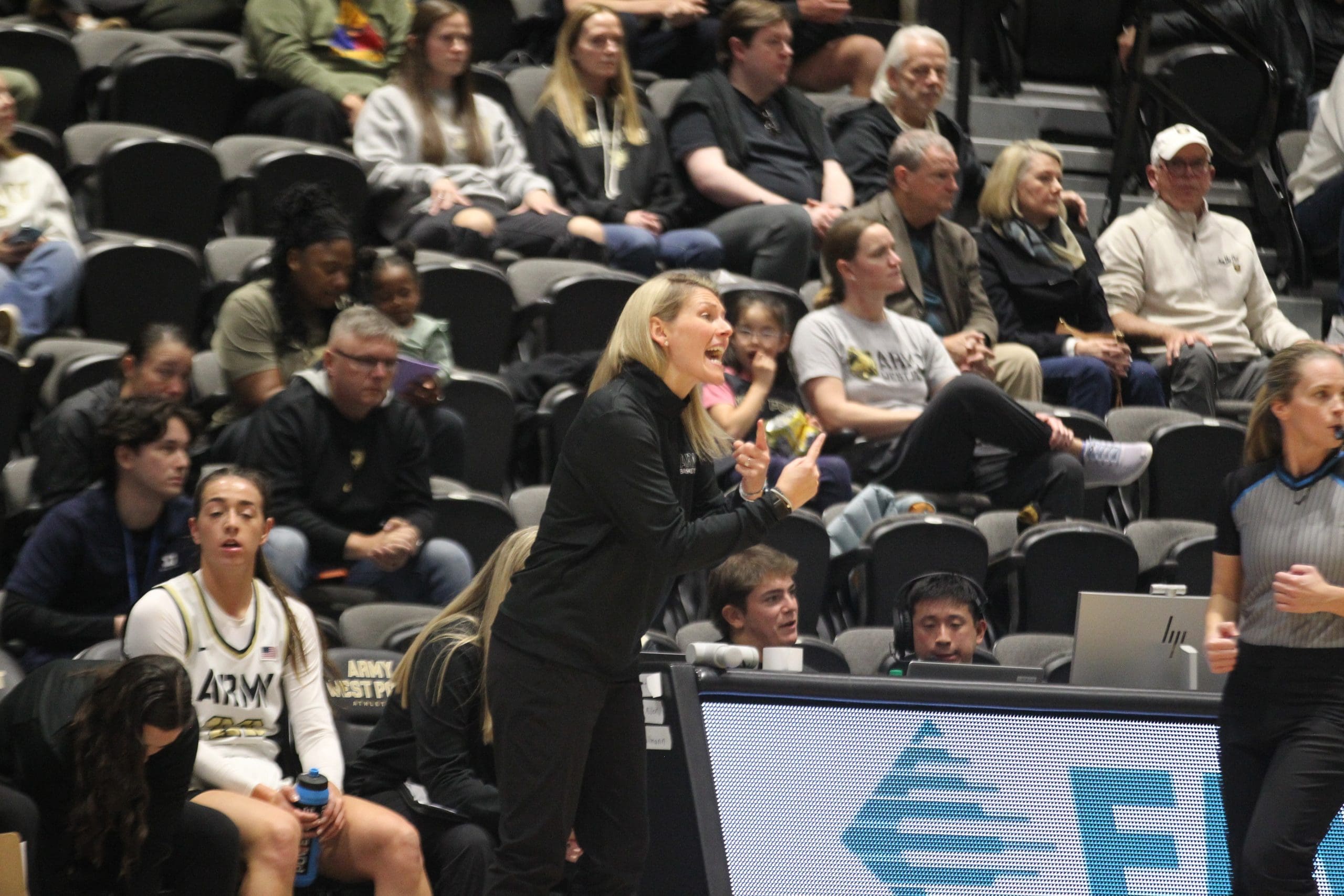 Army West Point women's basketball head coach Katie Kuester coaching from the sideline during her debut game