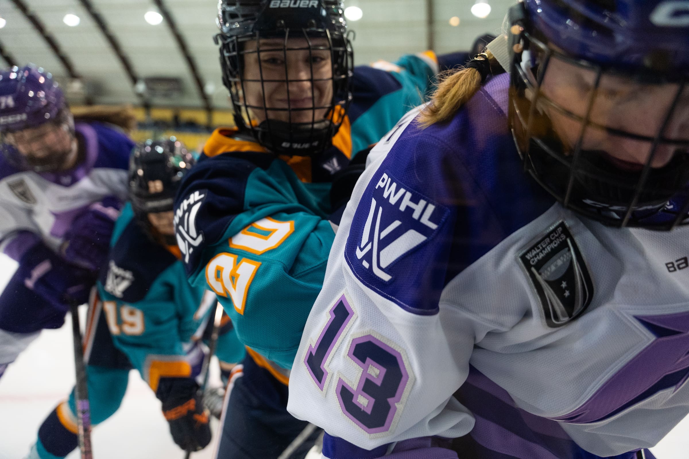 Allyson Simpson number 20 of New York Sirens delivers hit along boards against Minnesota PWHL player at Codey Arena