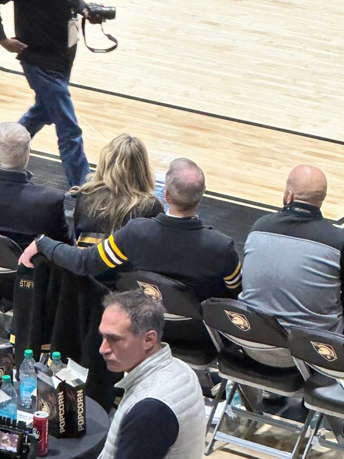 Army West Point Men's Hockey Head Coach Zach McKelvie taking in the game courtside.