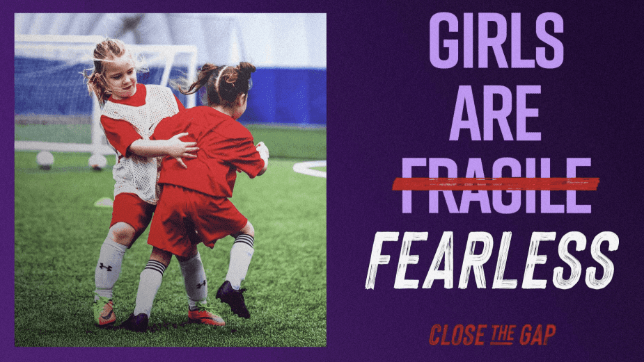 Young girls playing youth soccer in red jerseys with Close the Gap campaign message Girls Are Fearless
