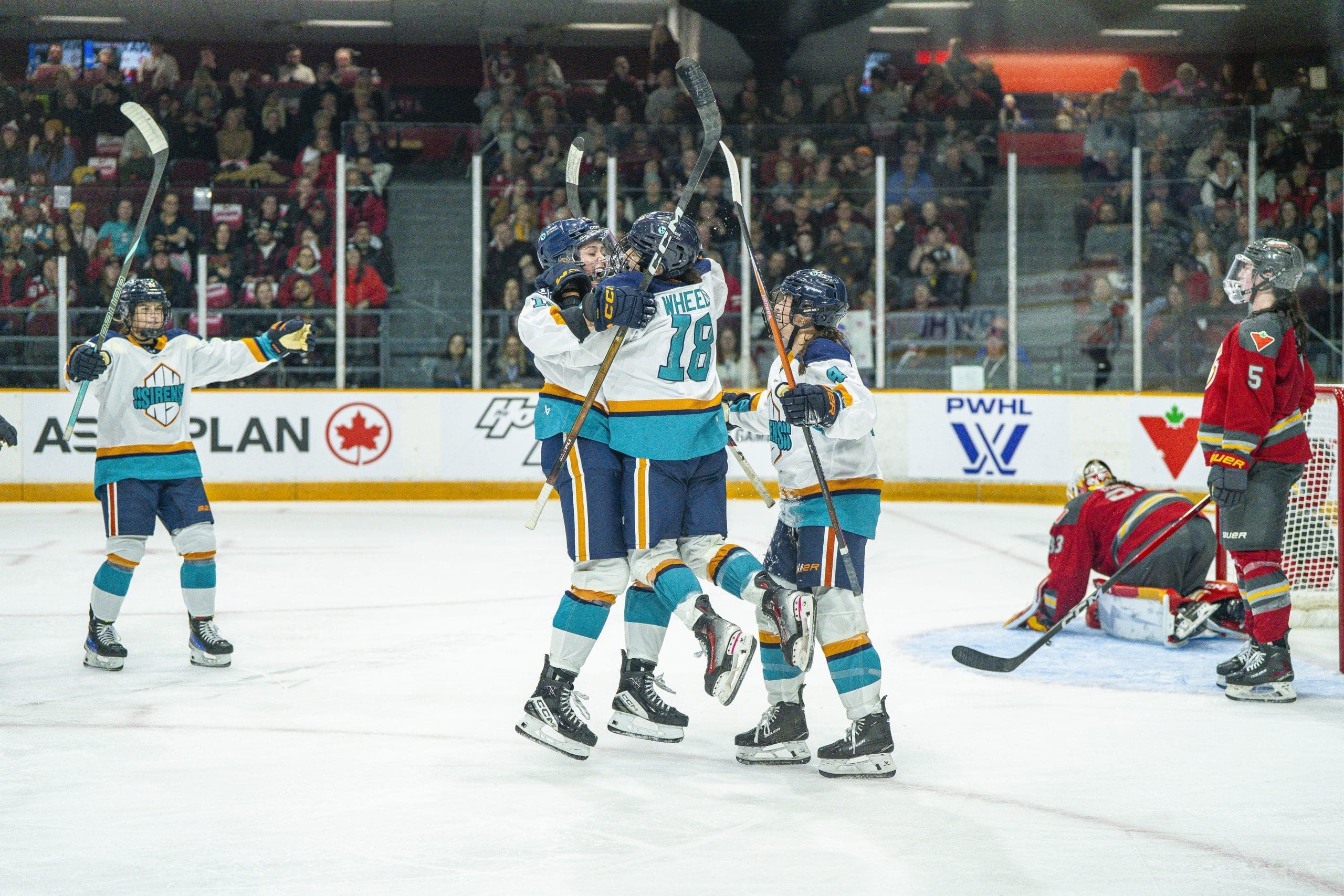 New York Sirens forward Taylor Girard celebrates her hat trick with rookie Maddi Wheeler, who assisted on all three goals, during the 2025-26 PWHL season opener against the Ottawa Charge at TD Place in Ottawa, Ontario, on November 22, 2025.