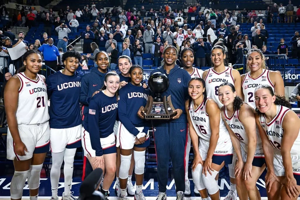 UConn Women's Basketball team celebrates with Armed Forces Classic championship trophy after 79-66 victory over Louisville at Naval Academy Alumni Hall
