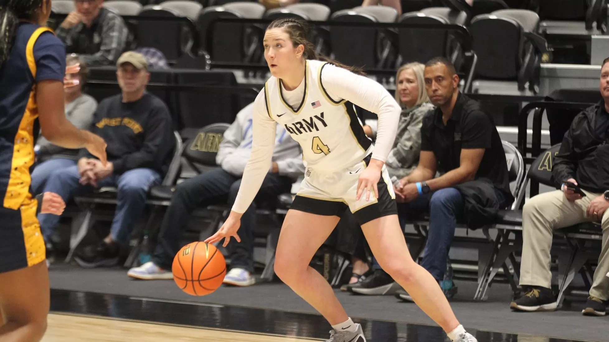 Army West Point women's basketball players celebrate enthusiastically from the bench during game at Mohegan Sun Arena, November 2025