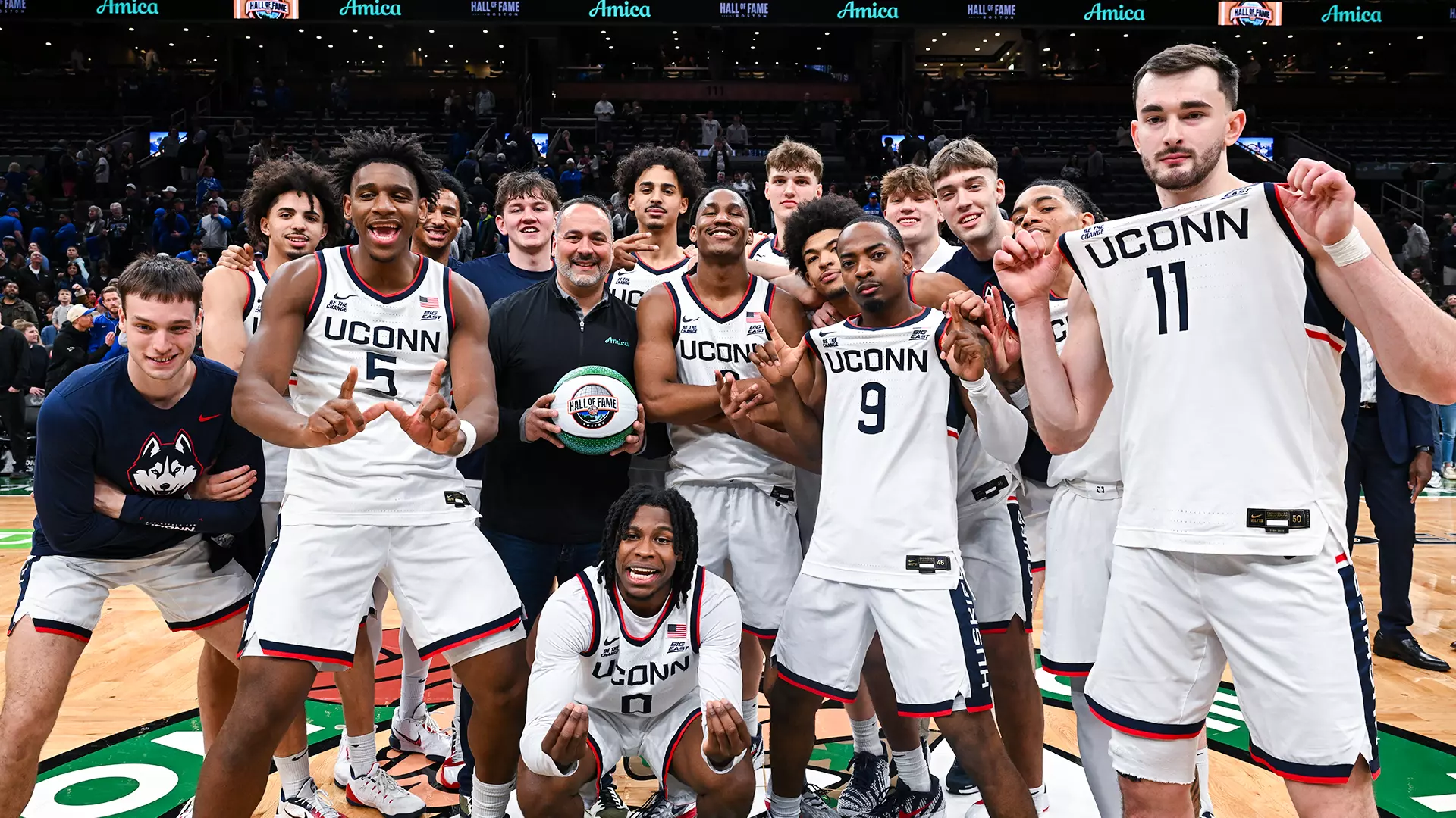 UConn Huskies celebrate with Hall of Fame Series trophy at midcourt TD Garden