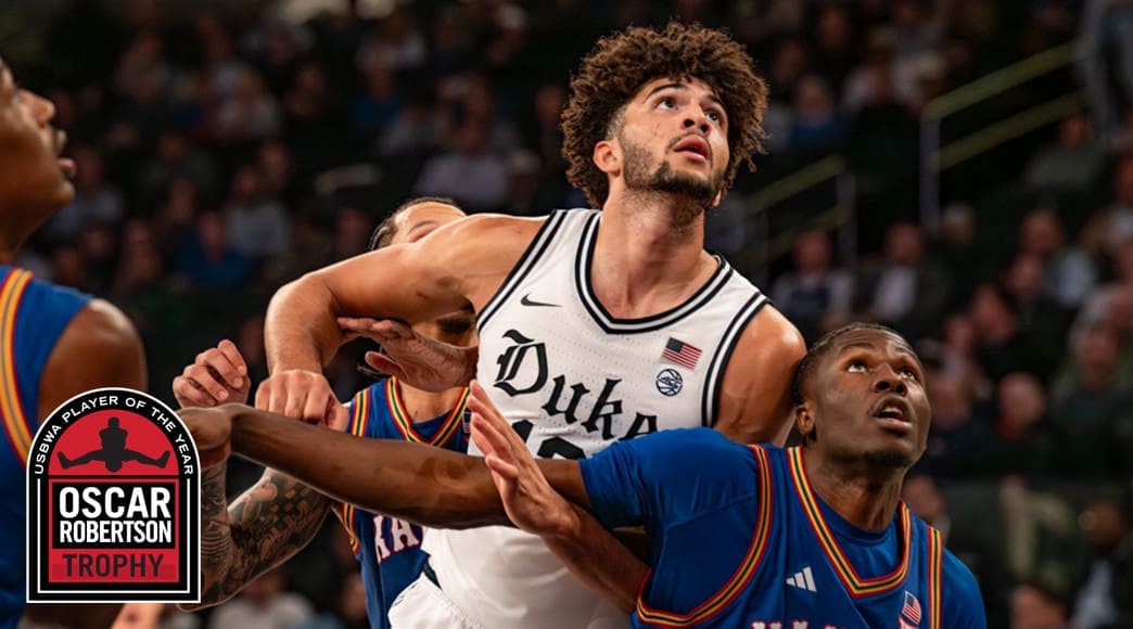 Duke Blue Devils freshman forward Cameron Boozer boxes out for a rebound during November 2025 action with the Oscar Robertson Trophy Player of the Year logo displayed in the lower left corner