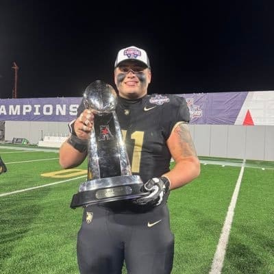 Army center Brady Small holds American Athletic Conference championship trophy after Black Knights victory