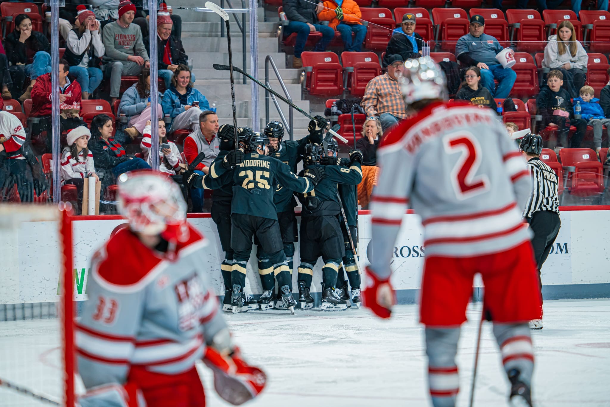 Army West Point hockey players celebrate Jack Ivey third period goal in 3-3 tie with Sacred Heart at Martire Family Arena