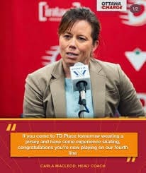 Ottawa Charge Head Coach Carla MacLeod speaks at a press conference microphone, wearing a tan blazer against a red Ottawa Charge branded backdrop