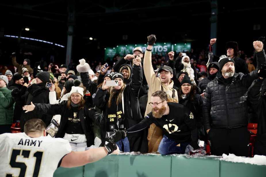 12/27/25, Boston, Massachusetts , Fenway Park , (#51) Brady Small of the Army Black Knights celebrates with fans following Army’s win over the UConn Huskies during the Wasabi Fenway Bowl . Mandatory Credit: Jose Pichirilo / Bad Dawg Sports