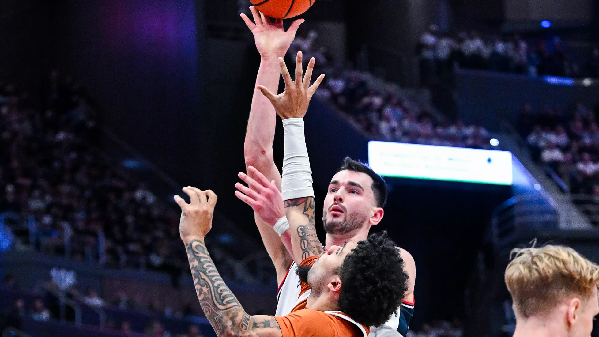 UConn’s Alex Karaban shoots over a Texas defender during a men’s basketball game.