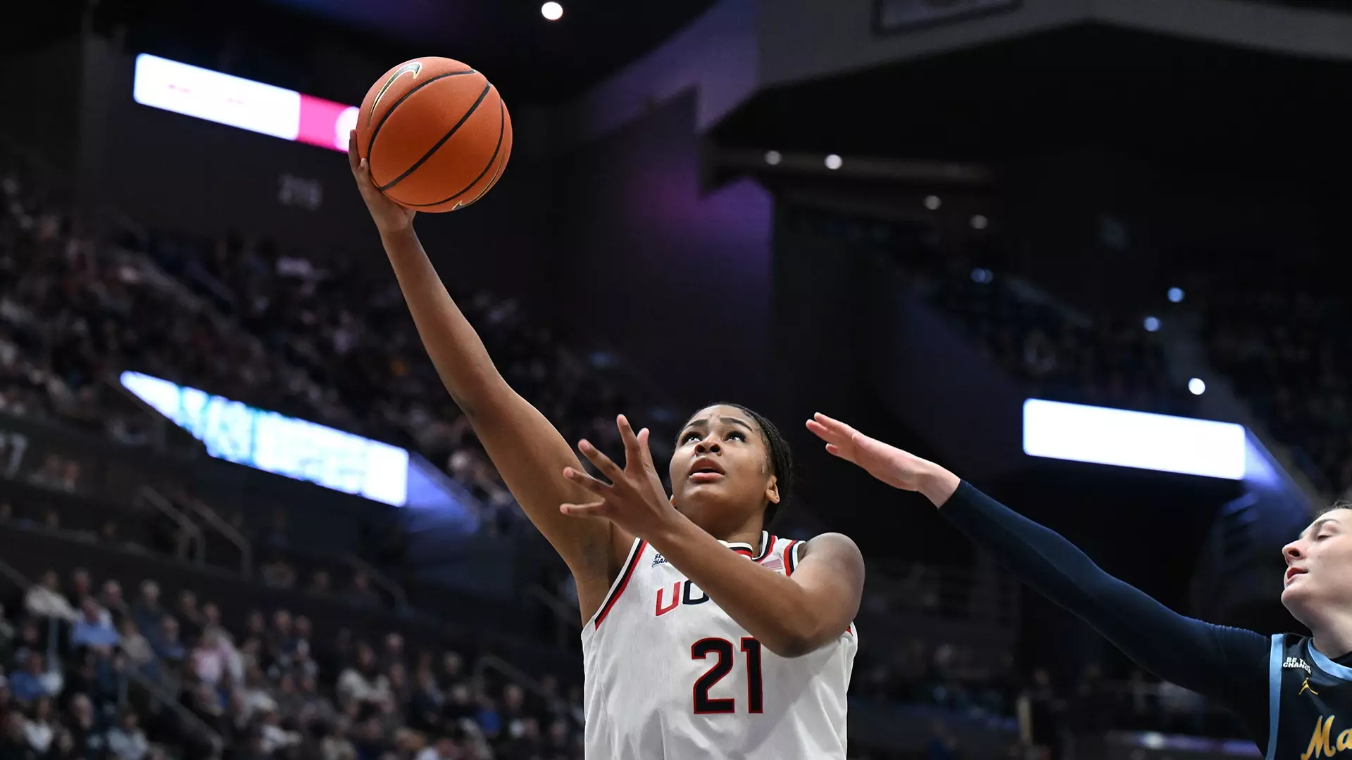UConn forward Sarah Strong, wearing jersey number 21, drives to the basket for a layup during a game against Marquette. Mandatory Credit: UConn