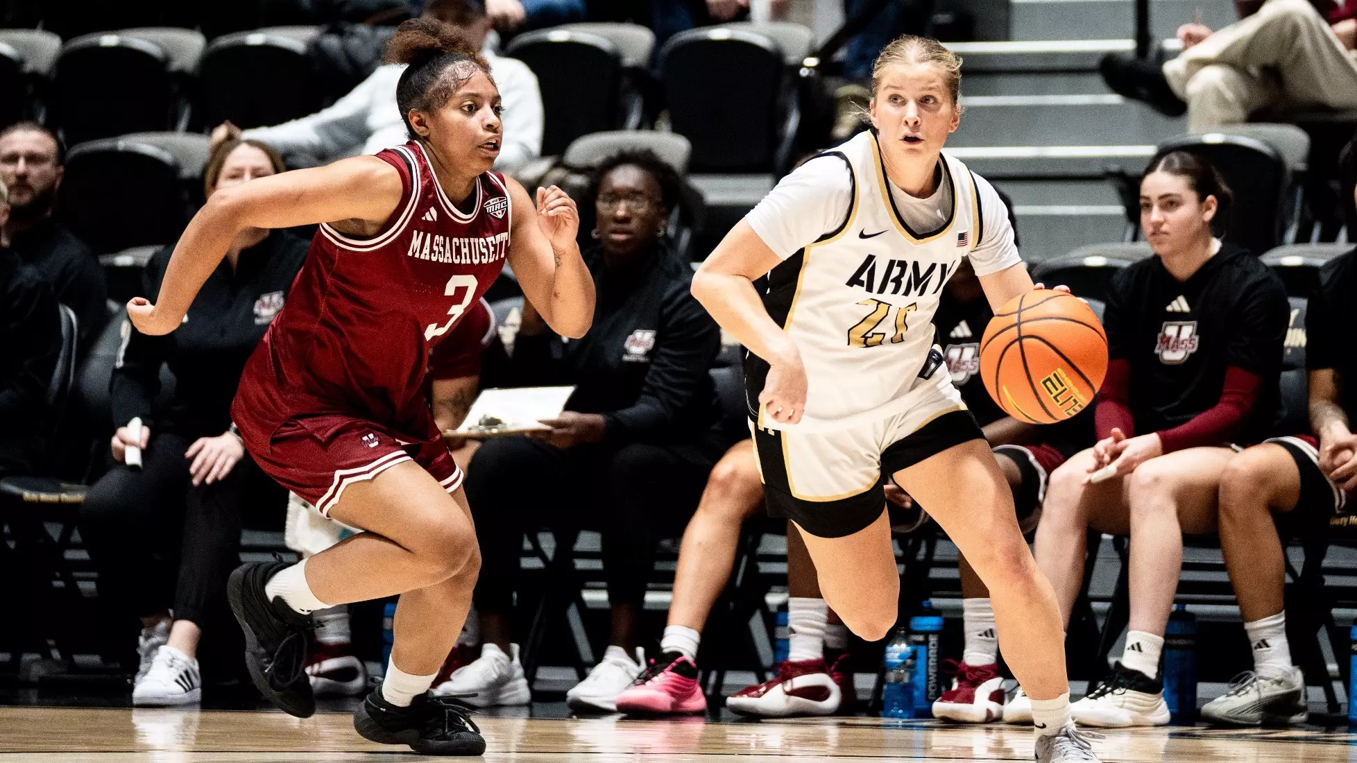 Army West Point senior Reese Ericson celebrates scoring her 1,000th career point, holding the game ball while teammates and fans cheer. Mandatory Credit: Army Athletics