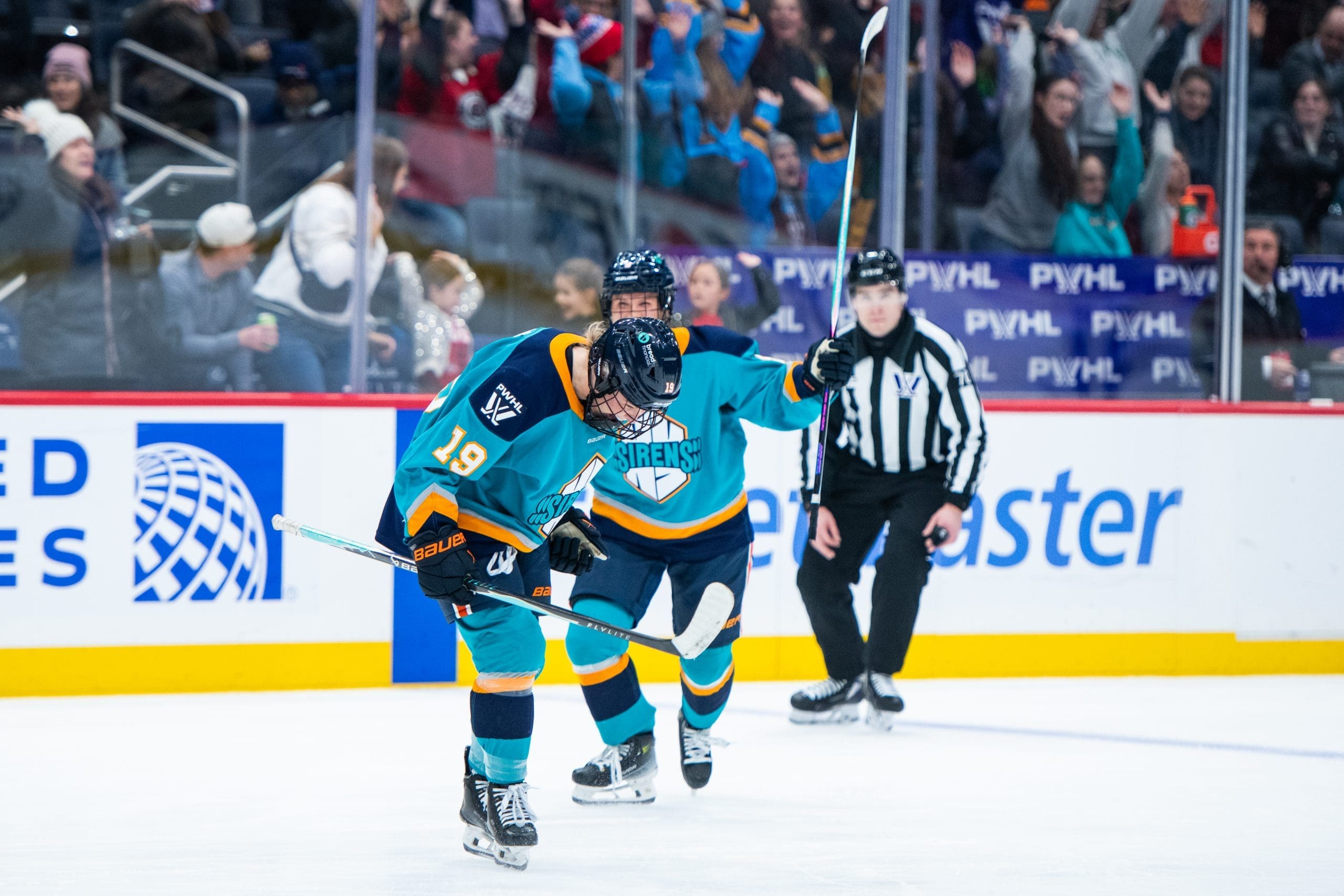 New York Sirens forward Paetyn Levis celebrates after scoring the game-winning goal against the Montréal Victoire as fans erupt in the background. Mandatory Credit: PWHL/Danielle Hersh.