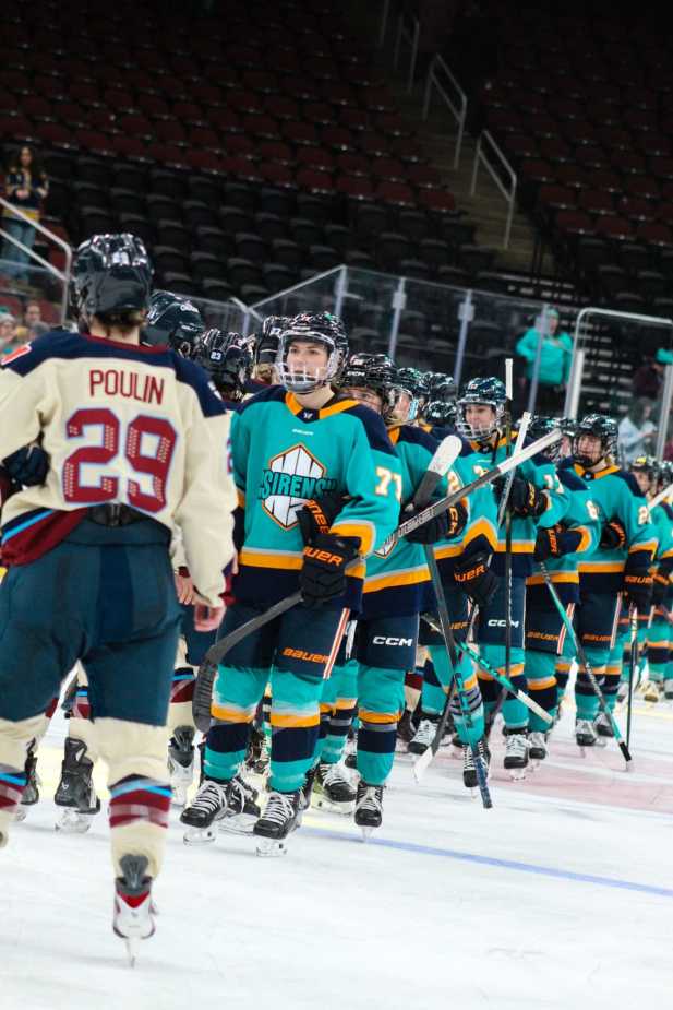 Players from the New York Sirens and Montréal Victoire line up for the traditional postgame handshake at center ice.