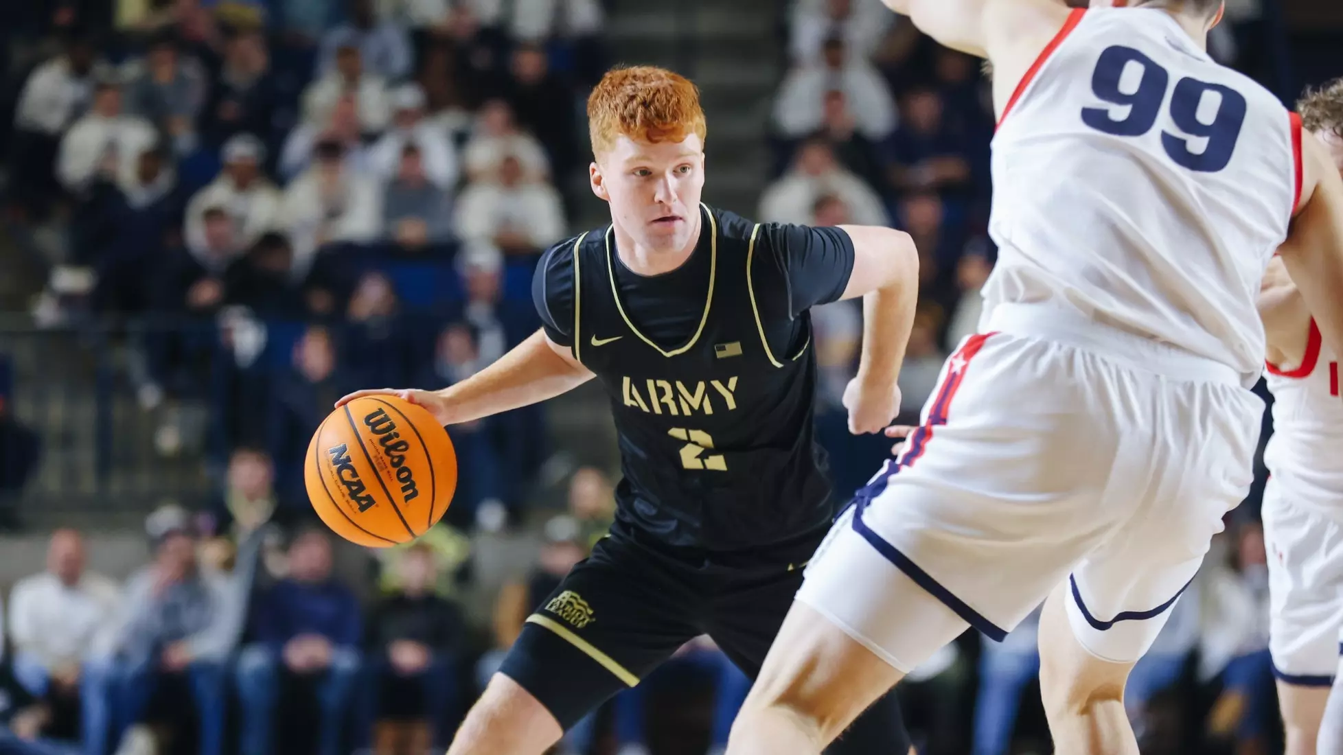 Army Black Knights guard Ryan Curry drives toward the basket against Navy during an Army–Navy men’s basketball game.