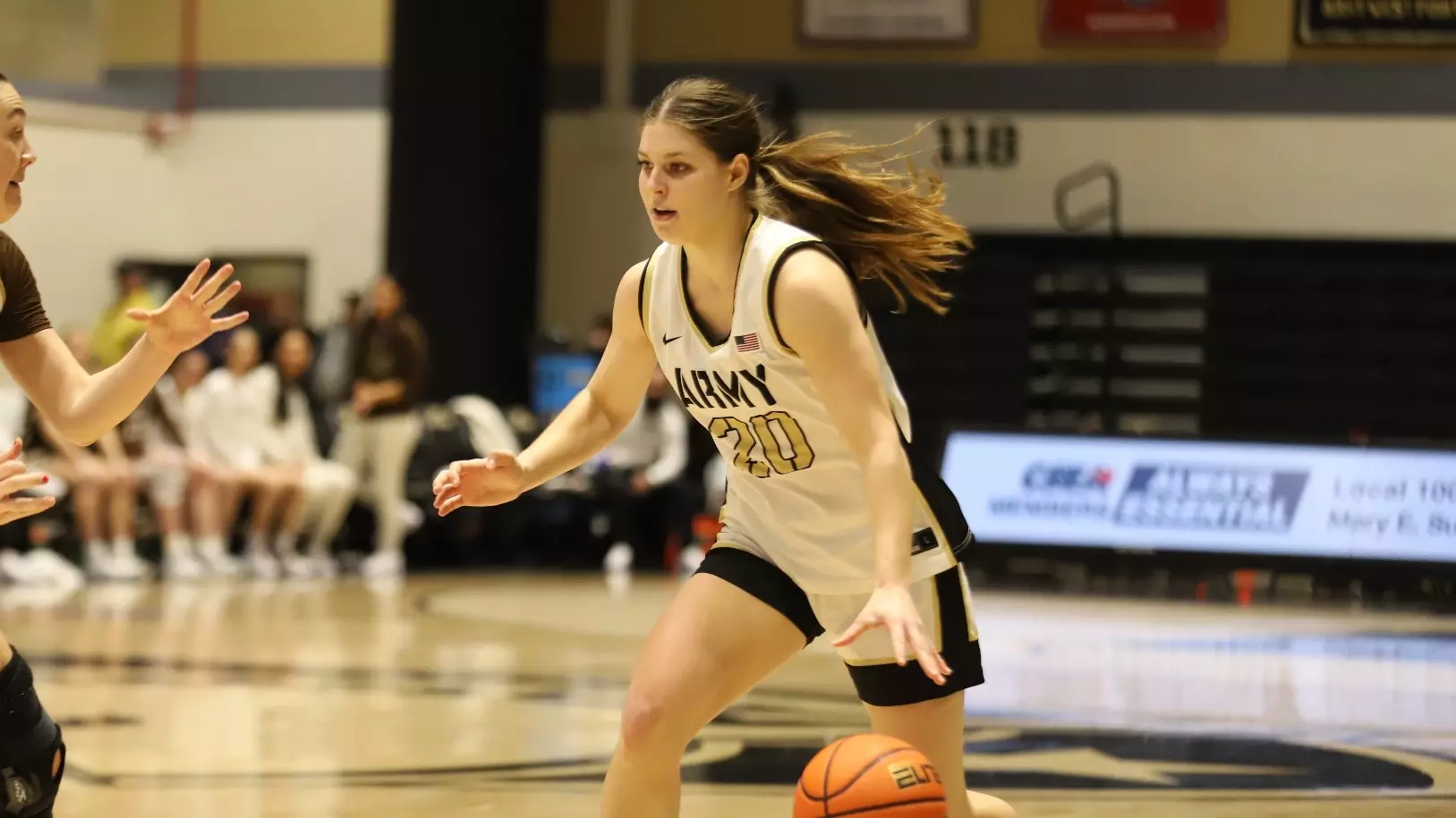 Camryn Tade of the Army Black Knights dribbles the basketball during a game, focused on her defender. Mandatory Credit: Army Athletics