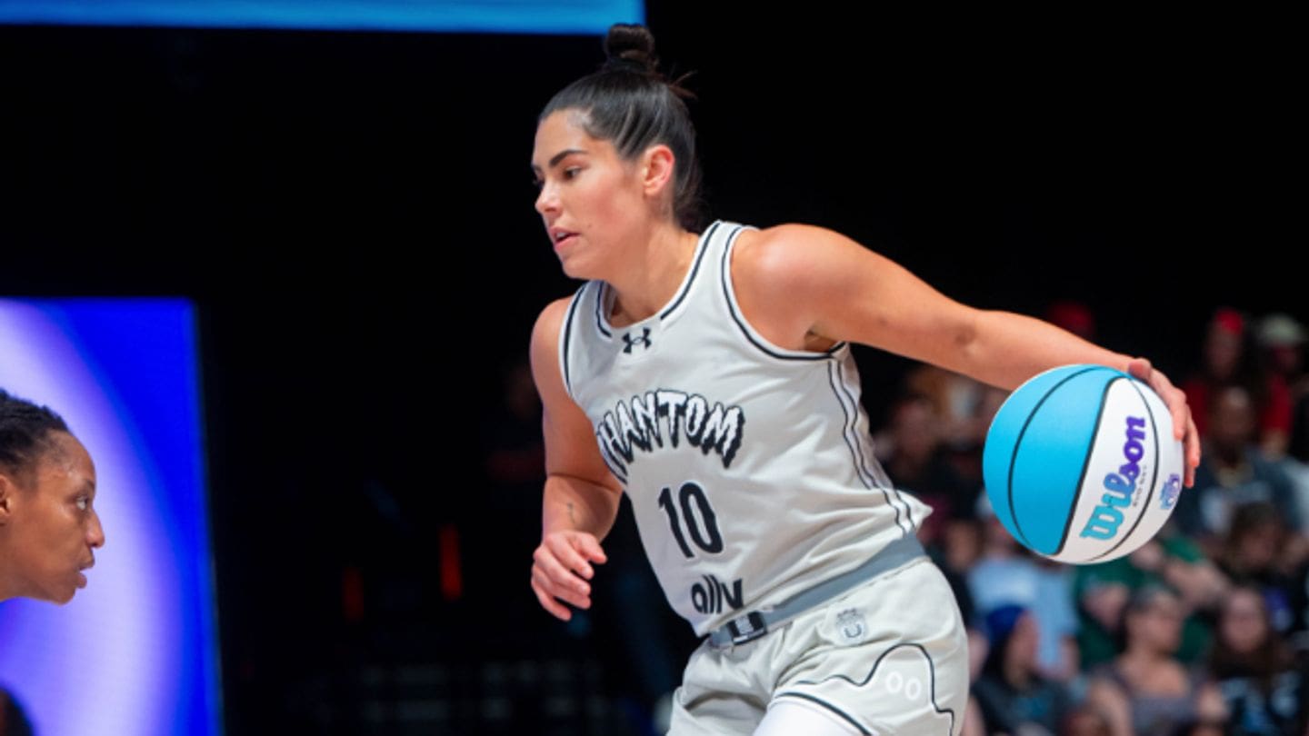 Kelsey Plum (#10) of Phantom BC dribbles a blue and white Wilson basketball with her left hand, looking upcourt during an Unrivaled league game against Hive BC.