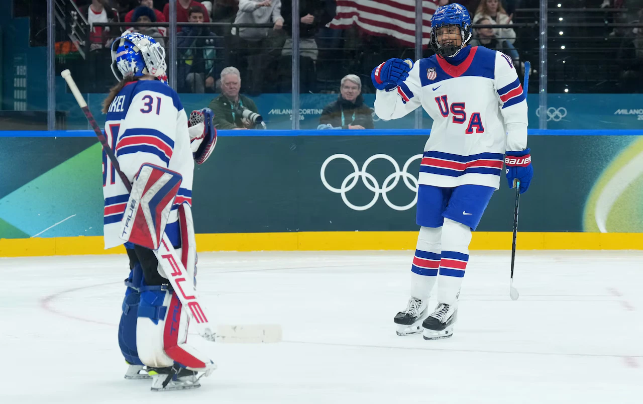 Team USA forward Laila Edwards celebrates with goaltender Aerin Frankel after scoring during the third period against Canada at the 2026 Winter Olympics in Milan, Italy.