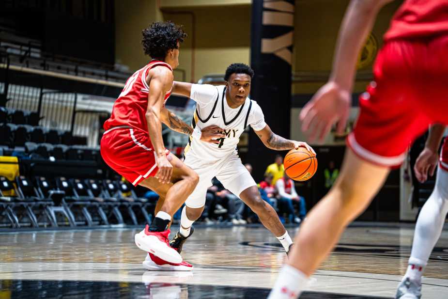 Army West Point guard Jaxson Bell dribbles toward the lane as a Boston University defender slides in front of him at Christl Arena.