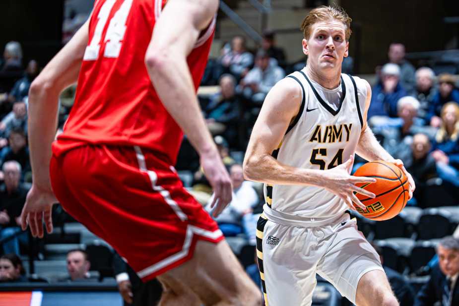 Army West Point forward Jorn Everson drives with the ball as a Boston University defender closes in at Christl Arena.