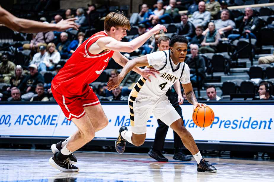 Army West Point guard Jaxson Bell dribbles past a Boston University defender and turns the corner toward the paint at Christl Arena.