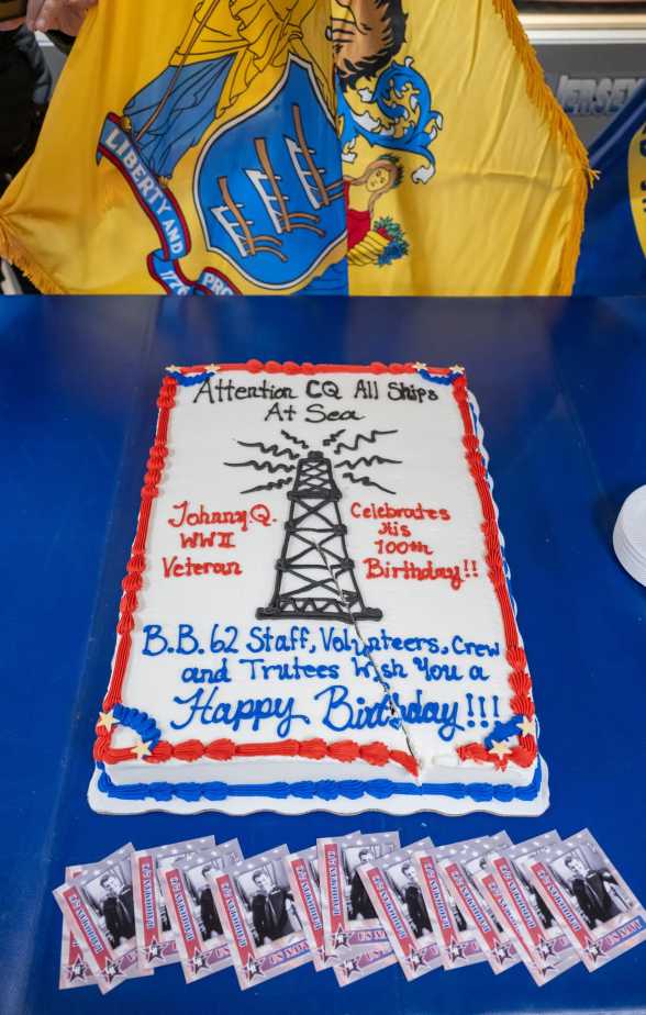 A decorated sheet cake honoring Johnny Q’s 100th birthday is displayed on a table during the celebration aboard the Battleship New Jersey Museum in Camden, N.J.