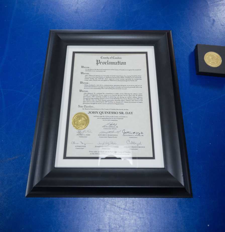 A framed Camden County proclamation declaring “John Quinesso Sr. Day” sits on a table during Johnny Q’s 100th birthday recognition event aboard the Battleship New Jersey Museum in Camden, N.J.