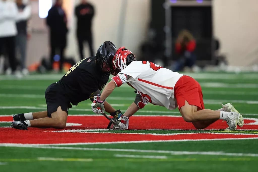 Army and Rutgers players battle at the faceoff X during their men’s lacrosse matchup in Piscataway, New Jersey.