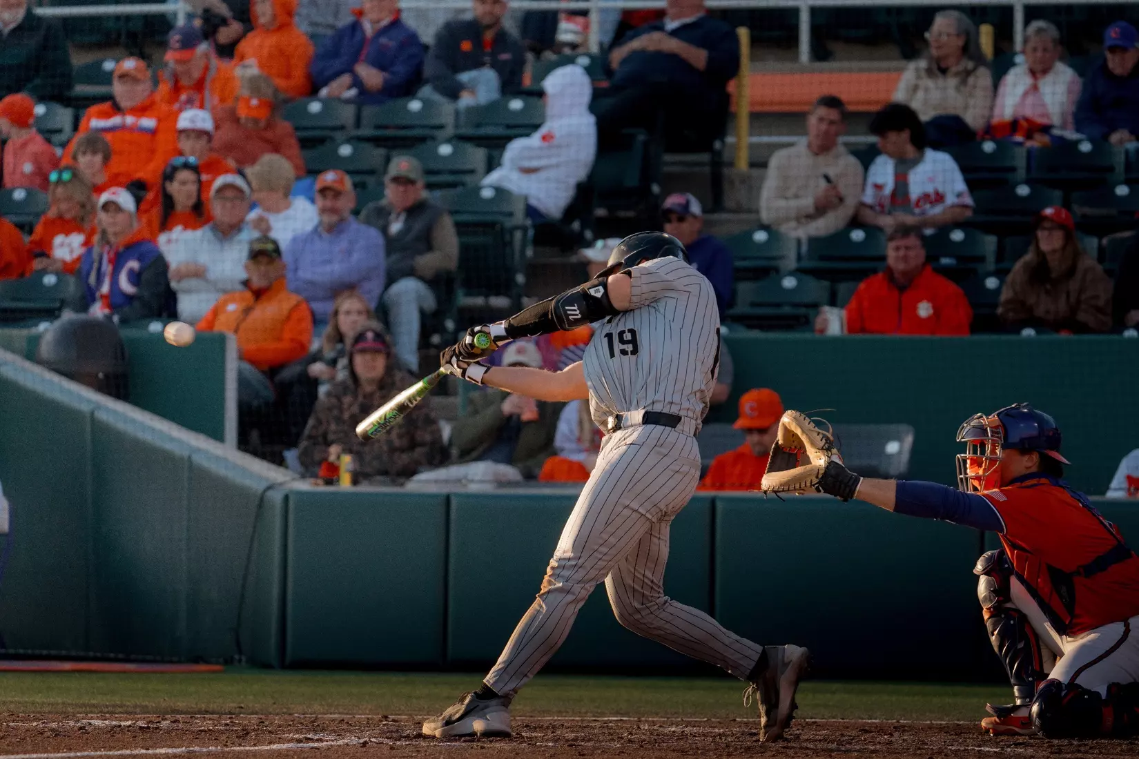 Army catcher Jack Quinlan swings at a pitch during an at-bat.