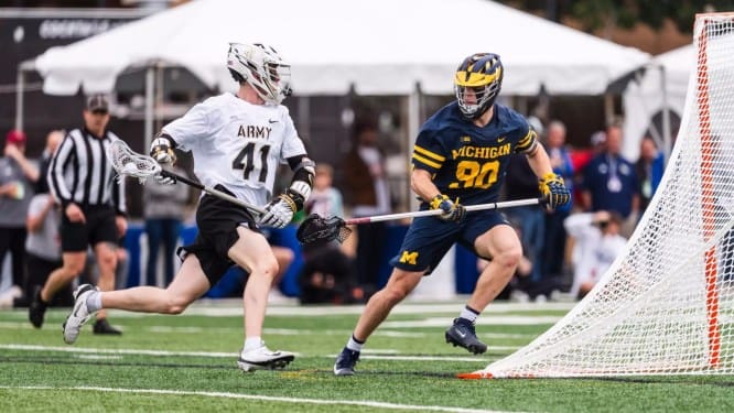 No. 10 Army's Gunnar Fellows (41) attacks the Michigan goal during a 13-11 victory in Atlanta.