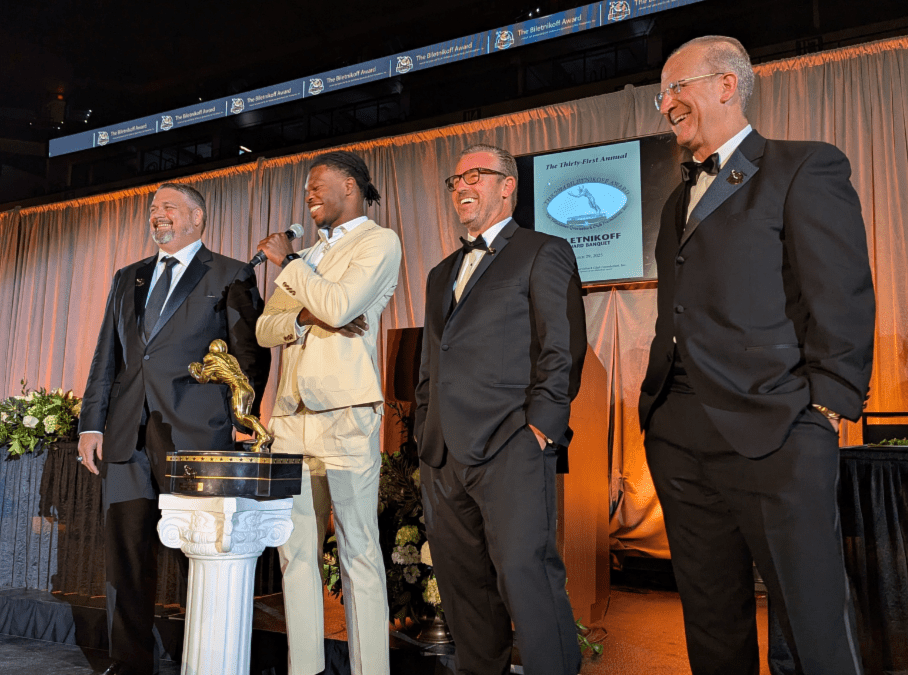 Foundation Chairman Charles Hopkins presented the beautiful Biletnikoff Award trophy to All-America and Heisman Memorial Trophy Winner Travis Hunter with Coach Michael Pollock and the 1992 Heisman Memorial Trophy winner and national champion Gino Torretta, keynote speaker, at the 31st Biletnikoff Award Banquet with 700 patrons in attendance on Saturday March 29, 2025.