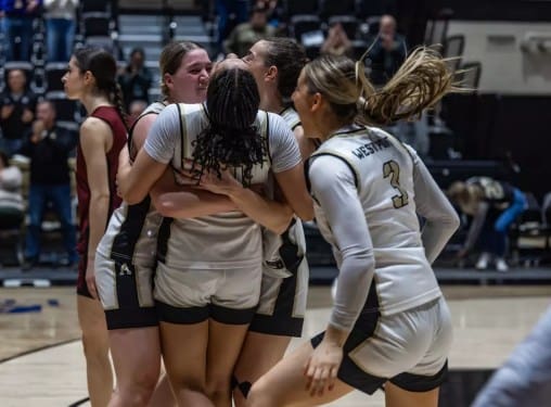 Army West Point players Brooke Wilson, Taylor Wilson, Kya Smith, and Reganne Reardon celebrate together on the court after their Patriot League quarterfinal victory.