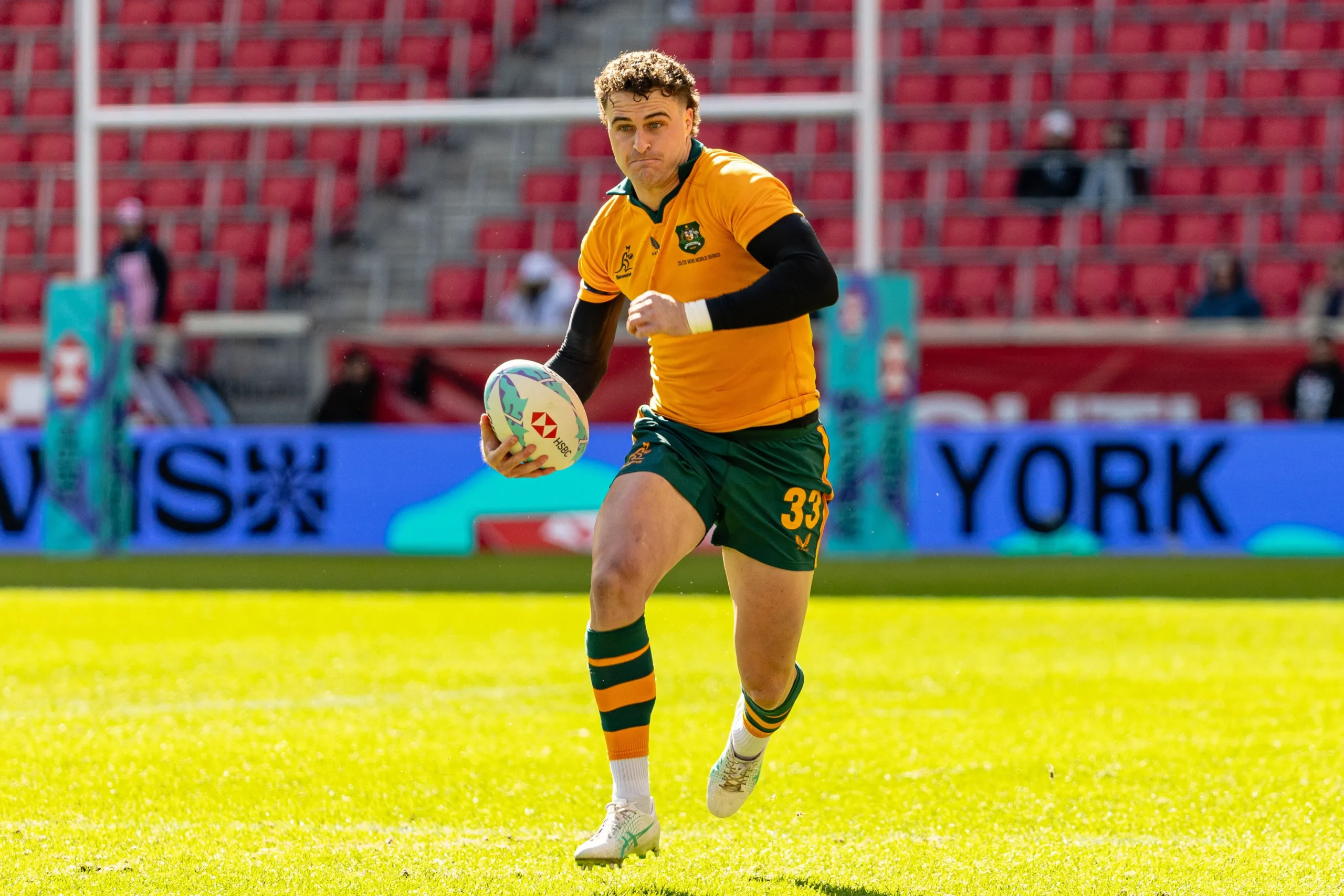 An Australian men’s rugby sevens player sprints with the ball during their dominant win over France at the HSBC SVNS event in New York.