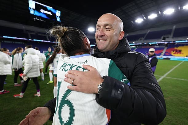 Denver Summit FC head coach Nick Cushing embraces defender Carson Pickett (#16) on the field after a victory against NJ/NY Gotham FC at Sports Illustrated Stadium.