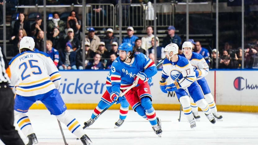 Mika Zibanejad skates with the puck on the ice.