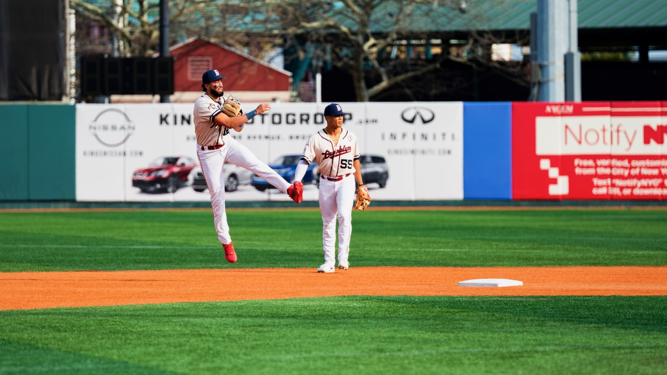 Brooklyn Cyclones shortstop Antonio Jiménez leaps into the air while making a throw to first base during game action.