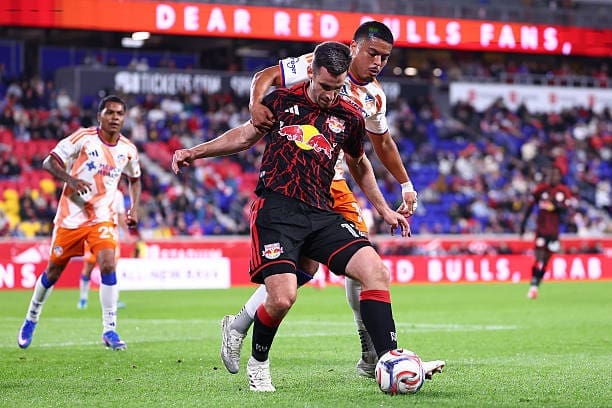 Red Bull New York's defender Dylan Nealis is Shielding the ball from FC Cincinnati's Attacker Evander late in the second half