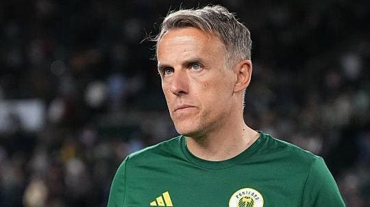 Phil Neville standing on the pitch at Providence Park