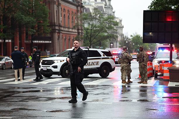 Officer and National Guard surveying the scene near the shooting.