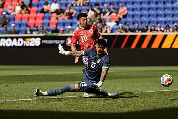 Ché Adams #10 of Scotland scores a goal past Guillermo Viscarra #23 of Bolivia during the first half of the international friendly match between Scotland and Bolivia at Sports Illustrated Stadium on June 06, 2026, in Harrison, New Jersey.