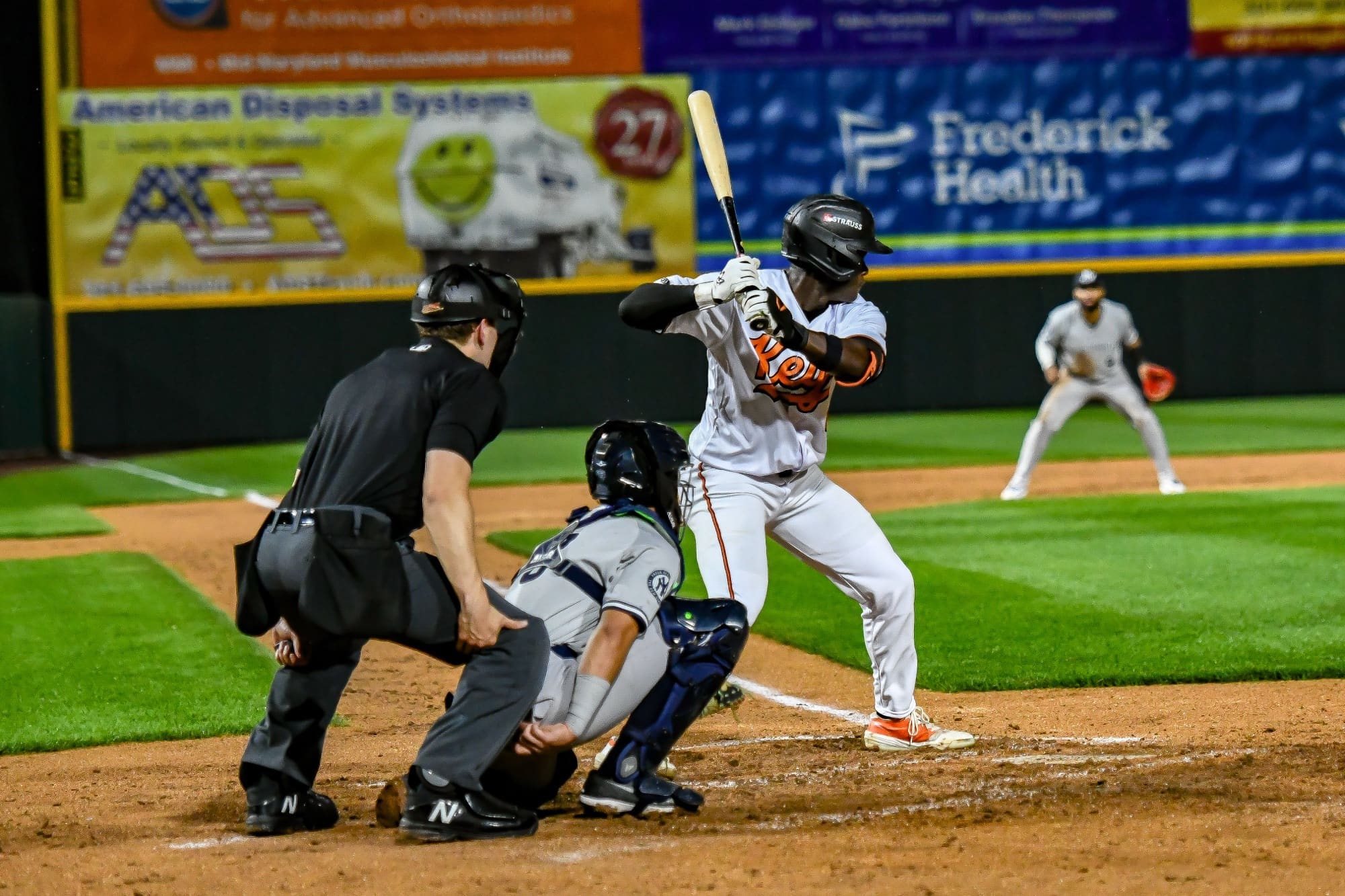 RJ Austin wear his white Frederick Keys baseball uniform at bat locked in and ready.